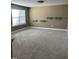 Bonus room featuring carpet floors, floating shelves, and a window at 9200 Torre Del Oro Pl, Raleigh, NC 27617