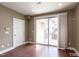 Bright room features a sliding glass door, a neutral color scheme, and smooth hardwood flooring at 9200 Torre Del Oro Pl, Raleigh, NC 27617