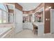 A neutral bathroom with an abundance of natural light, separate vanity and jetted tub at 1002 Pleasant Dr, Mebane, NC 27302
