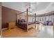 Luxurious bedroom featuring a four-poster bed, hardwood floors, and bay windows at 1002 Pleasant Dr, Mebane, NC 27302