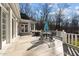 White brick exterior with large patio and outdoor furniture, perfect for entertaining at 1002 Pleasant Dr, Mebane, NC 27302