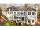A white brick house with decks, patios and a well-manicured lawn at 1002 Pleasant Dr, Mebane, NC 27302