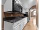 A kitchenette with stainless steel appliances and updated cabinetry, set off the bonus room at 1002 Pleasant Dr, Mebane, NC 27302