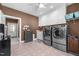 An additional laundry room with stainless steel appliances, storage, and neutral paint at 1002 Pleasant Dr, Mebane, NC 27302
