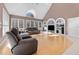Open living room with a vaulted ceiling, built-in shelving and large windows offering plenty of natural light at 1002 Pleasant Dr, Mebane, NC 27302