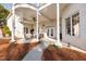 Covered patio with white brick, ceiling fan and elegant outdoor seating at 1002 Pleasant Dr, Mebane, NC 27302