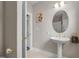 A quaint powder room with a pedestal sink and gold fixtures at 1002 Pleasant Dr, Mebane, NC 27302