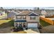 Aerial view of a two-story home with a two-car garage and a well-manicured front lawn at 1020 Broadlands Way, Graham, NC 27253