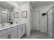 Bright bathroom with double sink vanity, framed mirror and glass enclosed walk-in shower at 1020 Broadlands Way, Graham, NC 27253
