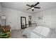 Clean bedroom with a black metal bed frame, ceiling fan, and carpet flooring at 1020 Broadlands Way, Graham, NC 27253