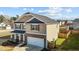 Charming two-story home featuring a stone facade, attached garage, and manicured lawn at 1020 Broadlands Way, Graham, NC 27253