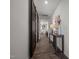 Well-lit hallway featuring wood floors, decorative accents, and sliding barn doors at 1020 Broadlands Way, Graham, NC 27253
