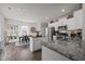 Well-lit kitchen featuring granite counters, stainless steel appliances, and open access to the dining area at 1020 Broadlands Way, Graham, NC 27253