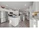 Modern eat-in kitchen with stainless steel appliances and an island with seating open to the living room at 1020 Broadlands Way, Graham, NC 27253