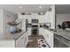 Bright kitchen with stainless appliances, granite counters, and a pantry door at 1020 Broadlands Way, Graham, NC 27253