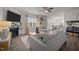 Bright living room with fireplace, ceiling fan, modern furniture, and open access to the kitchen at 1020 Broadlands Way, Graham, NC 27253