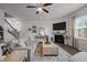 Comfortable living room with a fireplace, large TV, and neutral-toned furniture at 1020 Broadlands Way, Graham, NC 27253