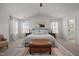 Bright primary bedroom with high ceilings, a cow wall art, lots of natural light, and an upholstered bed at 1020 Broadlands Way, Graham, NC 27253
