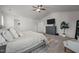 Primary bedroom featuring a dresser with a TV, ceiling fan, and carpet flooring at 1020 Broadlands Way, Graham, NC 27253