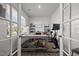 Bright and airy home office with a large desk, shelving, and workout equipment at 1020 Broadlands Way, Graham, NC 27253