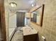 Bathroom with shower and tub, patterned flooring, and vanity with mirror at 1043 Cavel Chub Lake Rd, Roxboro, NC 27574