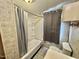Bathroom featuring a shower/tub combo and tiled walls with neutral grey accents at 1043 Cavel Chub Lake Rd, Roxboro, NC 27574