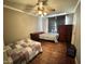 Cozy bedroom featuring two twin beds, wood floors, and natural light from the window at 1043 Cavel Chub Lake Rd, Roxboro, NC 27574