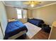 This bedroom features two twin beds, a window for natural light, and neutral-colored walls at 1043 Cavel Chub Lake Rd, Roxboro, NC 27574