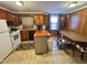 Functional kitchen with wood cabinetry, dining area, and appliances at 1043 Cavel Chub Lake Rd, Roxboro, NC 27574