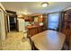 Kitchen area with a dining table and chairs. Cabinet-lined wall and wood accents at 1043 Cavel Chub Lake Rd, Roxboro, NC 27574