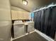 Functional laundry room equipped with a washer, dryer, and cabinets for ample storage space at 1043 Cavel Chub Lake Rd, Roxboro, NC 27574