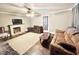 Spacious living room featuring a decorative fireplace, ceiling fan, and neutral tones at 1043 Cavel Chub Lake Rd, Roxboro, NC 27574