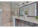 Bright bathroom with a glass-enclosed shower, double vanity, and modern lighting fixtures at 10510 Sablewood Dr # 114, Raleigh, NC 27617