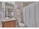 Well-lit bathroom featuring a vanity with a sink, toilet, and shower with a white curtain at 10510 Sablewood Dr # 114, Raleigh, NC 27617