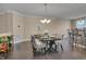 This dining room features hardwood floors, a chandelier, and dining set with seating for 6 at 10510 Sablewood Dr # 114, Raleigh, NC 27617