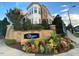 Beautifully landscaped entrance to The Cottages at Brier Creek, with colorful flowers and brickwork at 10510 Sablewood Dr # 114, Raleigh, NC 27617