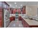 The spacious kitchen features granite countertops, dark cabinetry, and stainless steel appliances at 10510 Sablewood Dr # 114, Raleigh, NC 27617