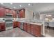 Updated kitchen features stainless steel appliances, granite countertops, and dark wood cabinets at 10510 Sablewood Dr # 114, Raleigh, NC 27617
