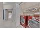 Convenient laundry room with red washer and dryer, shelving, and easy access to the rest of the house at 10510 Sablewood Dr # 114, Raleigh, NC 27617