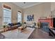 Bright living room featuring hardwood floors, a fireplace, large windows and comfortable seating at 10510 Sablewood Dr # 114, Raleigh, NC 27617