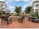 Inviting outdoor kitchen featuring built-in grill and fire pit surrounded by comfortable seating on a brick patio at 10510 Sablewood Dr # 114, Raleigh, NC 27617