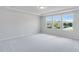 Bright, carpeted bedroom featuring three large windows and recessed lighting at 106 N Finley Landing Pkwy # 1, Smithfield, NC 27577