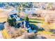 Aerial view of the home with surrounding landscape and community lake at 10620 Staghound Trl, Zebulon, NC 27597