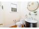 Charming bathroom featuring a modern vanity, round mirror, stylish fixtures, and bright natural light at 10620 Staghound Trl, Zebulon, NC 27597