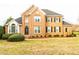 Charming two-story brick home features a well-manicured lawn and lush greenery at 10620 Staghound Trl, Zebulon, NC 27597