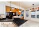Open-concept kitchen featuring a breakfast bar and a view into the cozy living room at 10620 Staghound Trl, Zebulon, NC 27597