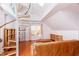 Bright living room features a spiral staircase, skylight, and hardwood floors at 10620 Staghound Trl, Zebulon, NC 27597