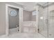 Luxurious bathroom with marble flooring, a soaking tub, and a glass-enclosed shower at 1107 S 2Nd St, Smithfield, NC 27577