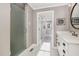 Bathroom with a glass-enclosed shower, marble vanity, and access to bedroom with bright windows at 1107 S 2Nd St, Smithfield, NC 27577
