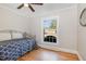 Cozy bedroom with hardwood floors, a modern ceiling fan, and a window providing natural light at 1107 S 2Nd St, Smithfield, NC 27577